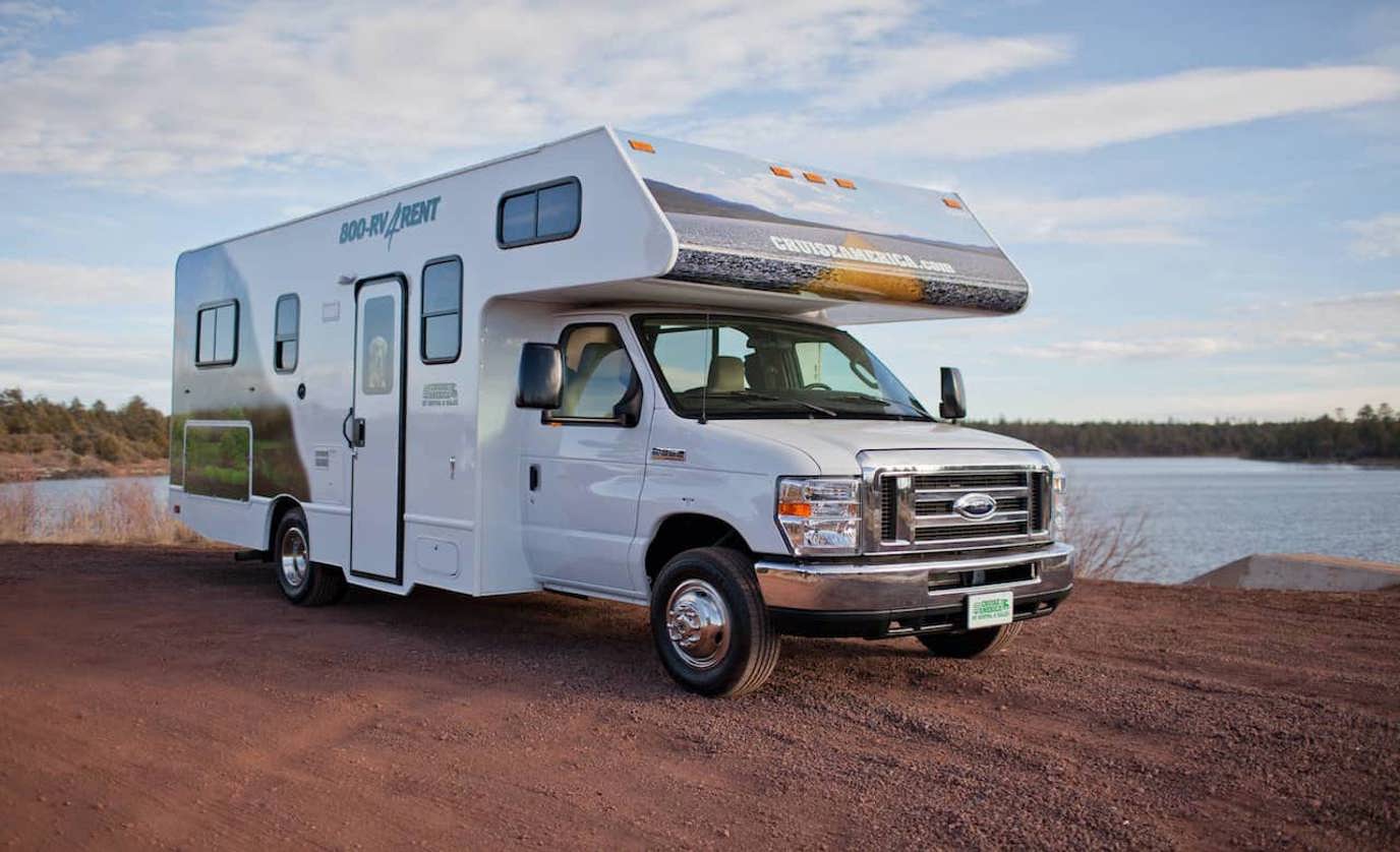 Family preparing a meal inside their rented Class C motorhome near RV Rental motorhome rental