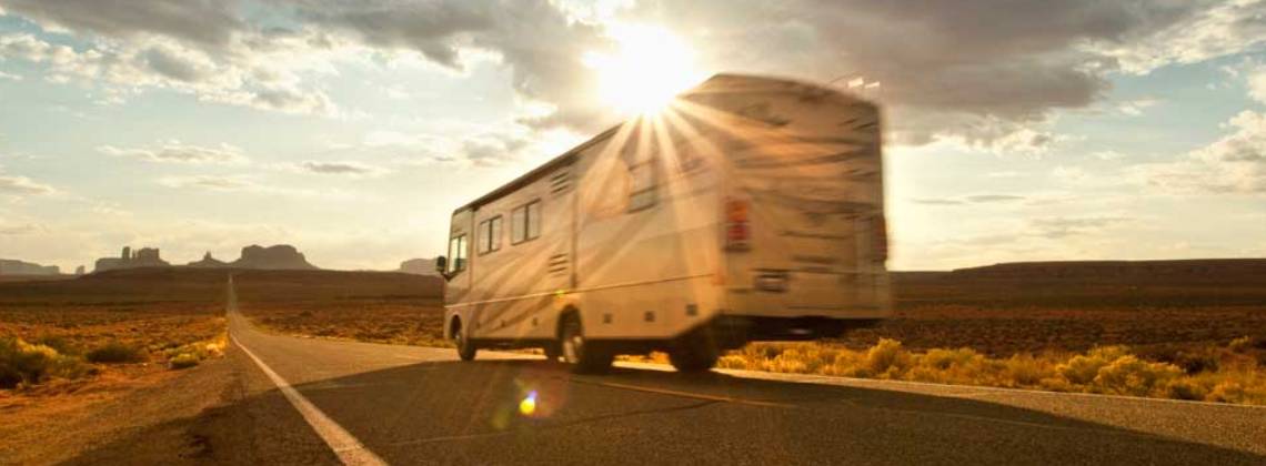 A rented motorhome driving through the iconic Monument Valley in the USA