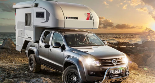 Tischer Truck Camper parked on a beach at sunset, showing a compact camping setup.