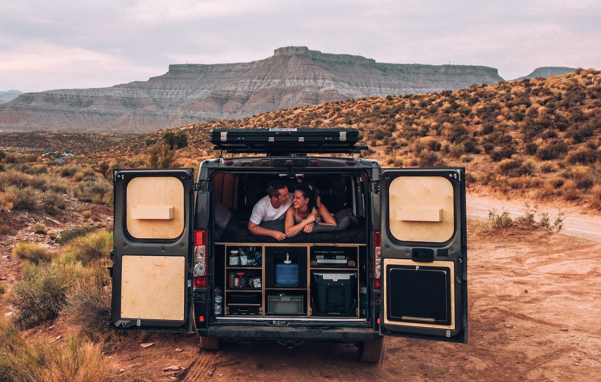 A campervan parked with a scenic Denver mountain backdrop