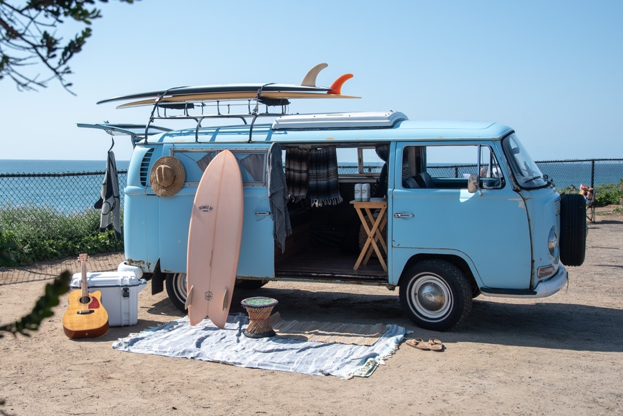 Happy couple enjoying their rented campervan in the Los Angeles area