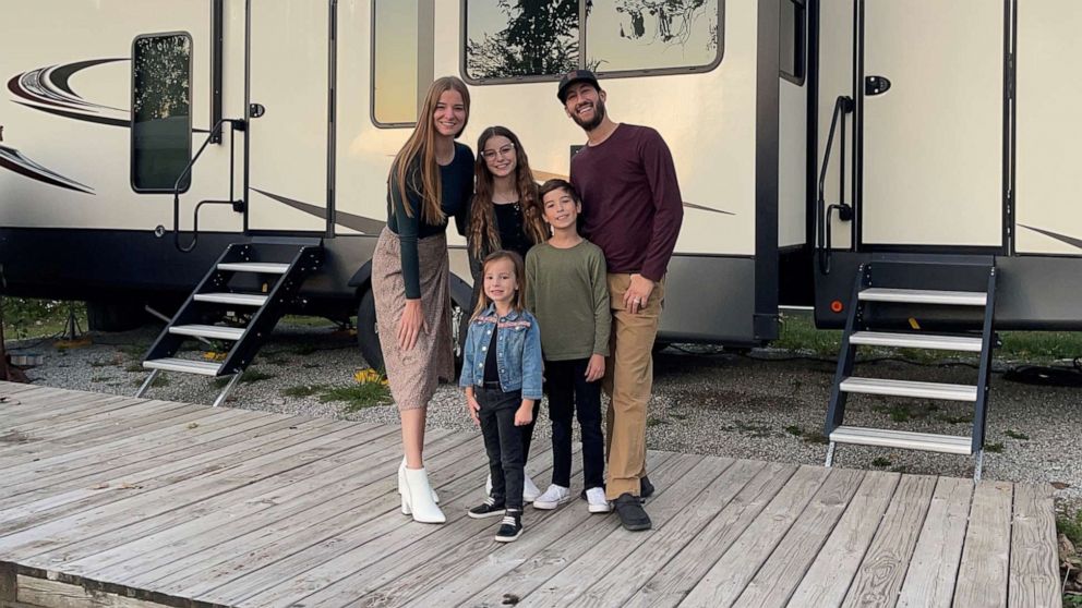 A family enjoying the outdoors next to their Class C motorhome rental near Los Angeles.