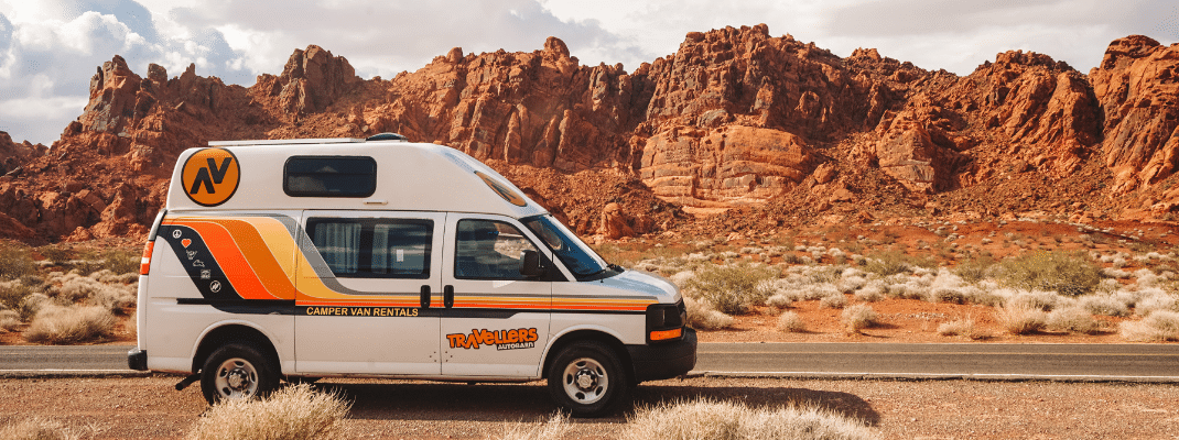 A campervan rented for a Los Angeles road trip parked near the beach