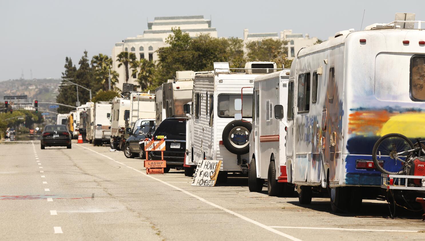 A row of different RV classes parked near a beach in Los Angeles, illustrating the variety available