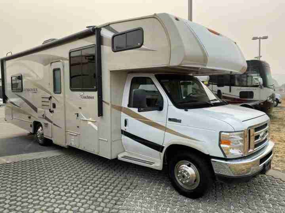 A family enjoying the interior of their spacious rented motorhome in Los Angeles.