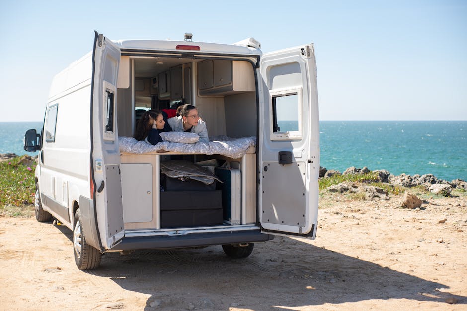 A couple enjoying the view from their rented campervan in San Diego