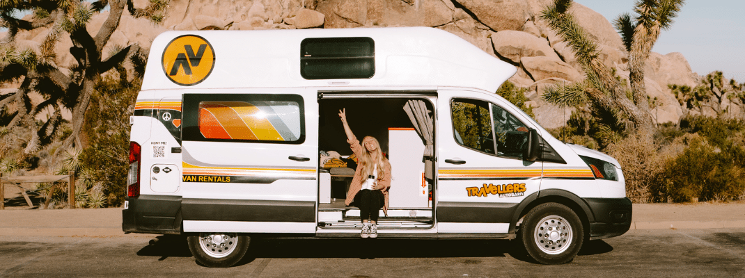 Couple enjoying a meal inside their campervan on a Los Angeles road trip