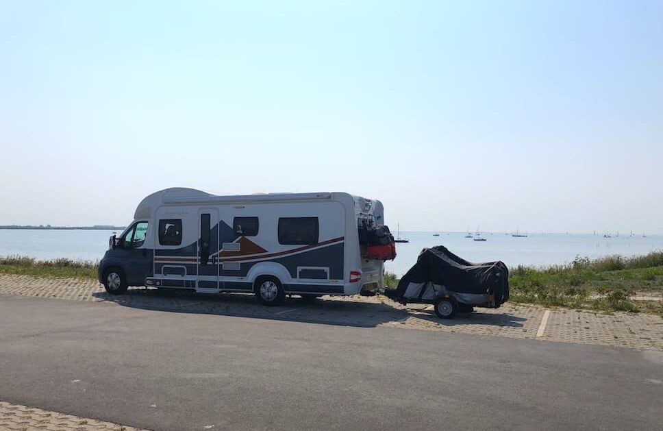A campervan parked by a scenic canal in Giethoorn, Netherlands.