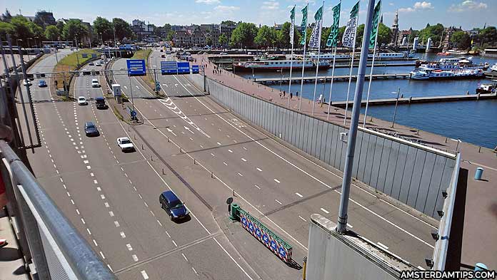 A car navigating a street in Amsterdam with cyclists