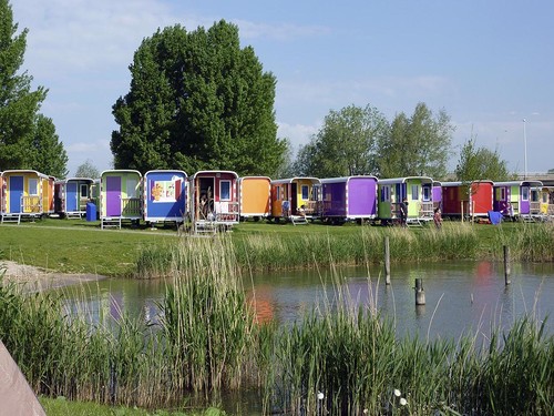 A well-organized campsite in Amsterdam with RVs parked near the water, like Camping Zeeburg.
