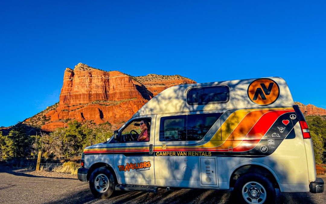 A campervan parked in front of the iconic Red Rock Canyon formations near Las Vegas