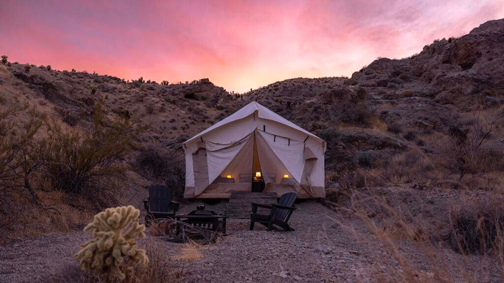 Couple enjoying the sunset outside their RV near Las Vegas.