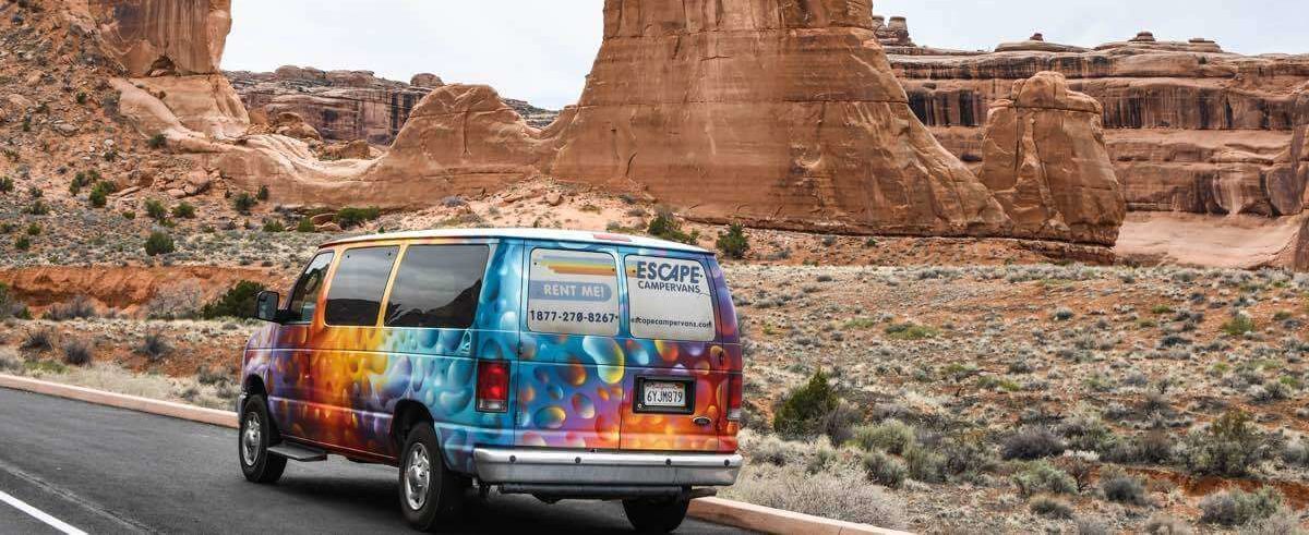 A campervan drives through the desert roads near Las Vegas