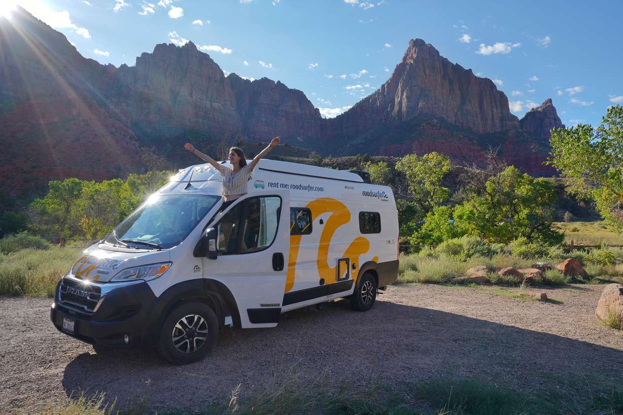 A campervan on a scenic road near Salt Lake City, illustrating rental costs